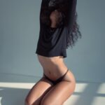 woman kneeling on floor while hands up