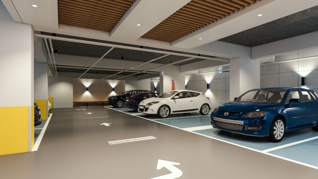 Modern indoor parking garage with parked cars.