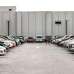 person walking in the middle on vehicles